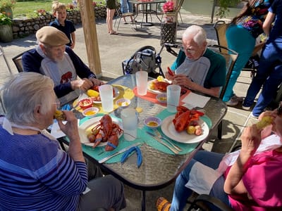 Residents enjoying a lobster feast outdoors