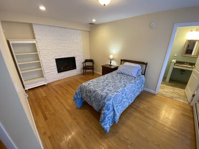 Cozy private room with a bed and fireplace