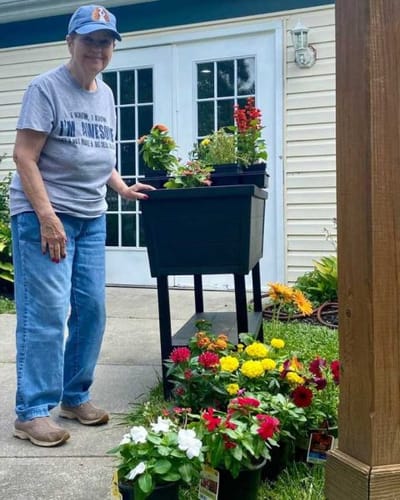 Resident planting flowers in outdoor space