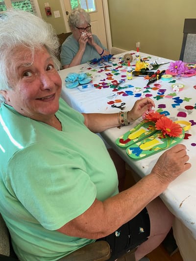 Residents engaged in a crafting activity at a table