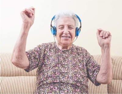 Senior woman enjoying music with headphones