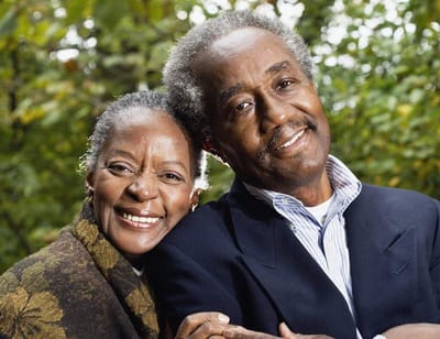 Smiling senior couple embracing outdoors