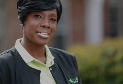 Staff member smiling outside the facility