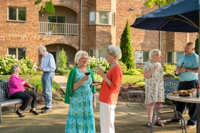 Residents enjoying food and drinks in a garden setting