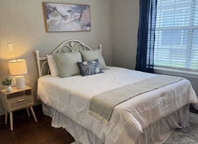 Neatly arranged bedroom with bed and decor