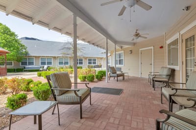 Covered outdoor seating area with landscaped garden