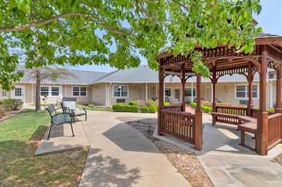 A gazebo in a landscaped courtyard at a senior living facility