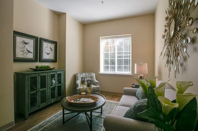 Cozy sitting area with plants and artwork