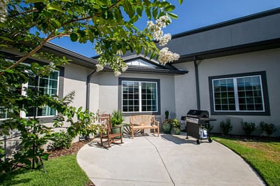 Outdoor seating area with grill and landscaping