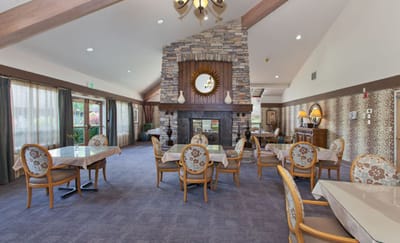 Interior view of a cozy common area with tables and chairs