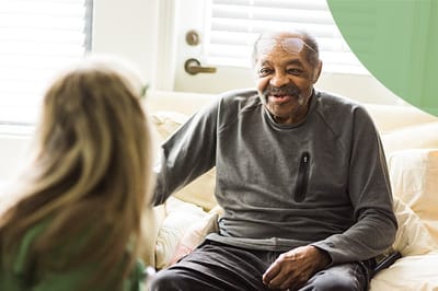 A resident smiling while engaged in conversation