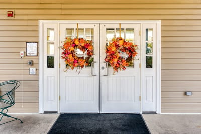 Entrance doors decorated with fall wreaths