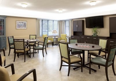 Common area with tables and chairs for activities