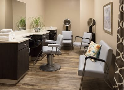 A hair salon area with styling chairs and mirrors
