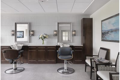 Beauty salon area with chairs and mirrors