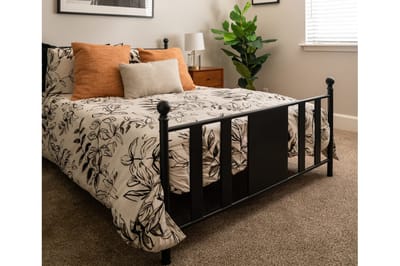 Cozy bedroom setup with floral bedding and decorative pillows