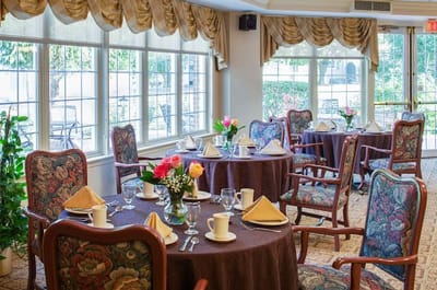 Elegant dining area set with flowers and tableware