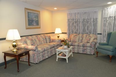 Cozy common area with floral couches and lamps