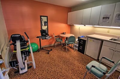 Fitness area with exercise equipment and chairs
