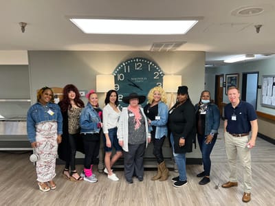 Staff and residents posing together in a common area