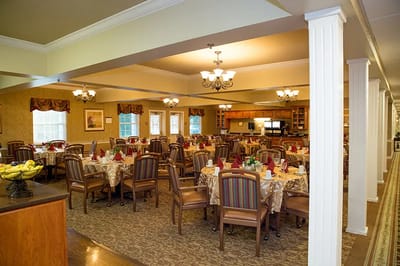 Dining room with tables set for residents