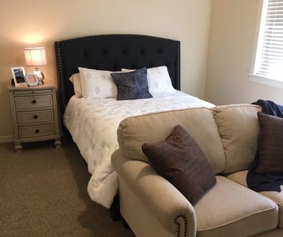 Cozy resident bedroom with a bed and seating area