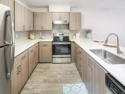 Bright, modern kitchen interior with wooden cabinets