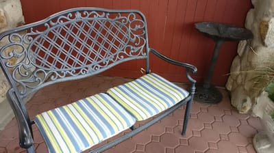 Outdoor seating area with a wrought iron bench