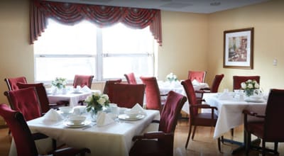 Dining room set up with tables and flowers