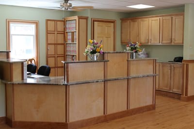 Reception area with wooden counter and flowers