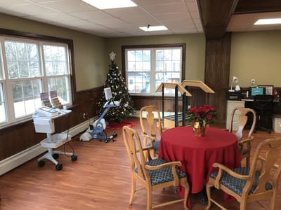 Common area with a holiday tree and therapy equipment