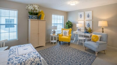 Brightly decorated resident room with furniture