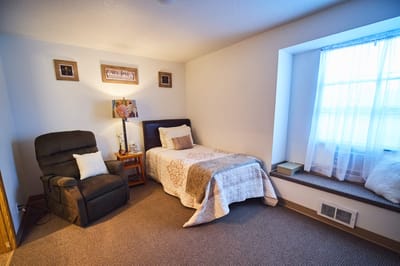 Cozy resident room with a bed and chair