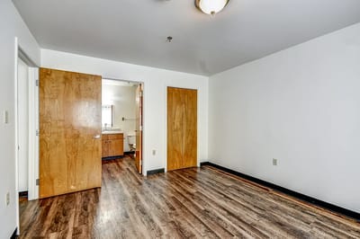 Interior view of a vacant resident room with wooden floors