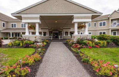 Exterior view of Granite Hill Estates with flower gardens