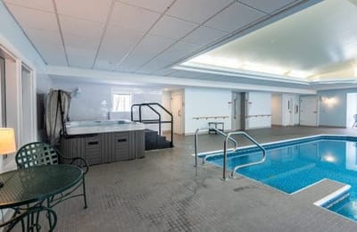 Indoor pool and spa area with seating