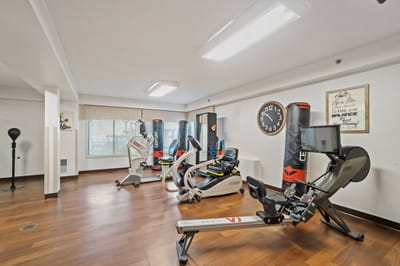 Interior fitness area with exercise equipment and motivational decor