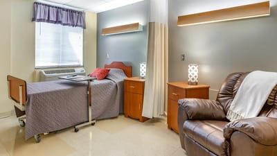 Cozy resident room with a bed and recliner