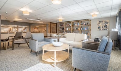 Welcoming common area with seating and bookshelves