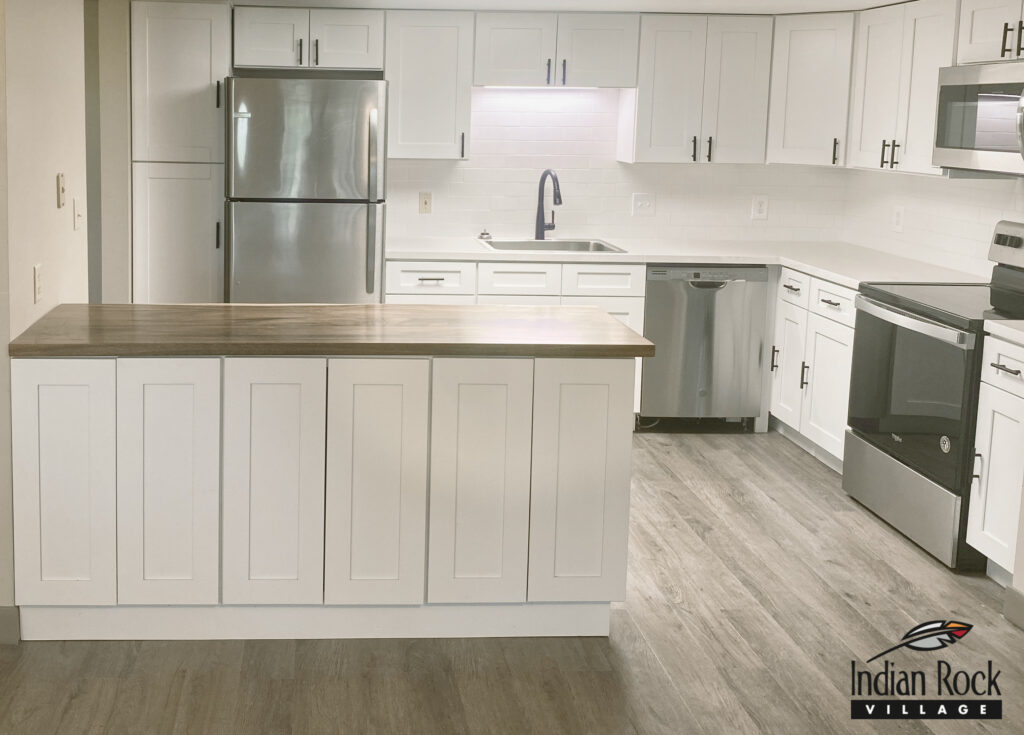 Bright kitchen area with modern appliances and logo