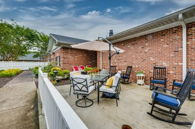 Outdoor patio area with seating and flowers