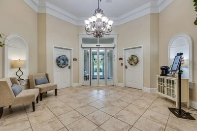 Welcoming lobby area with seating and chandelier