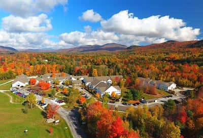 Aerial view of a senior living campus surrounded by autumn trees