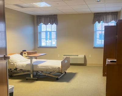 A bright private room with a hospital bed