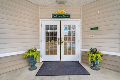 Entrance to Oaks at Cedar Shoals with welcome sign