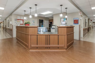 Facility reception area with a wooden counter and lighting
