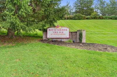 Signage for Rittenhouse Village at Muhlenberg surrounded by grass