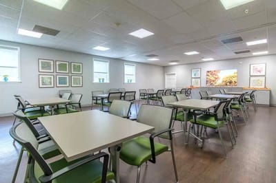 Bright dining area with multiple tables and artwork