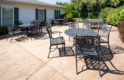 Outdoor seating area with decorative metal tables and chairs