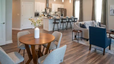 Bright interior common area with seating and dining space
